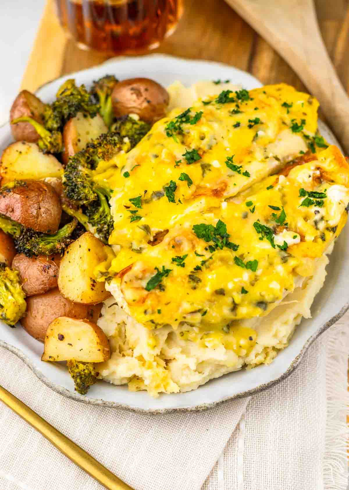 A plate of food featuring potatoes and broccoli, perfect as a cozy sheet pan dinner alongside flavorful Parmesan chicken.