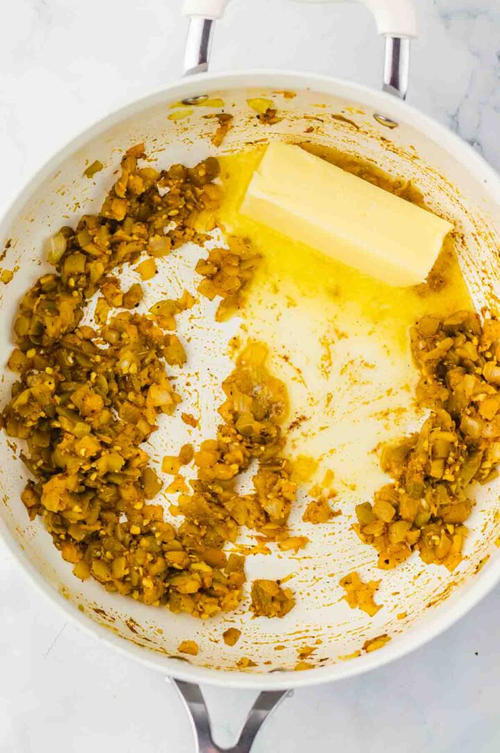 Chopped saut&eacute;ed mushrooms and a stick of butter melting in a white pan&mdash;perfect for adding rich flavor to White Chicken Chili or Mac And Cheese.