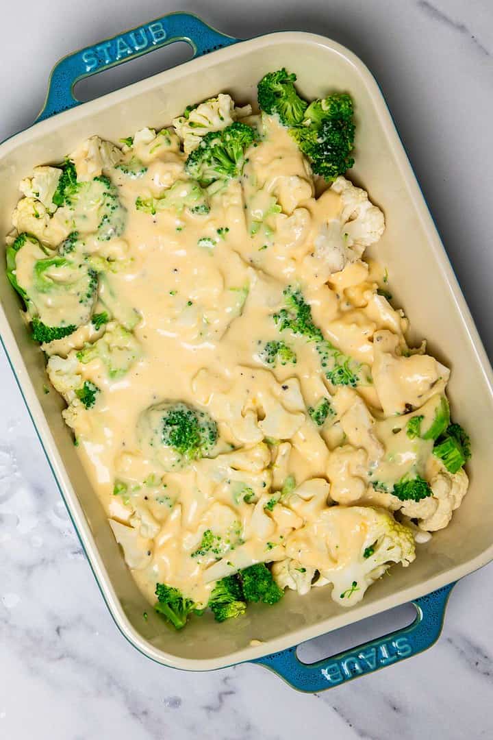 Broccoli and cauliflower florets in a baking dish topped with creamy cheese sauce, this Cheese Casserole is ready to be baked.