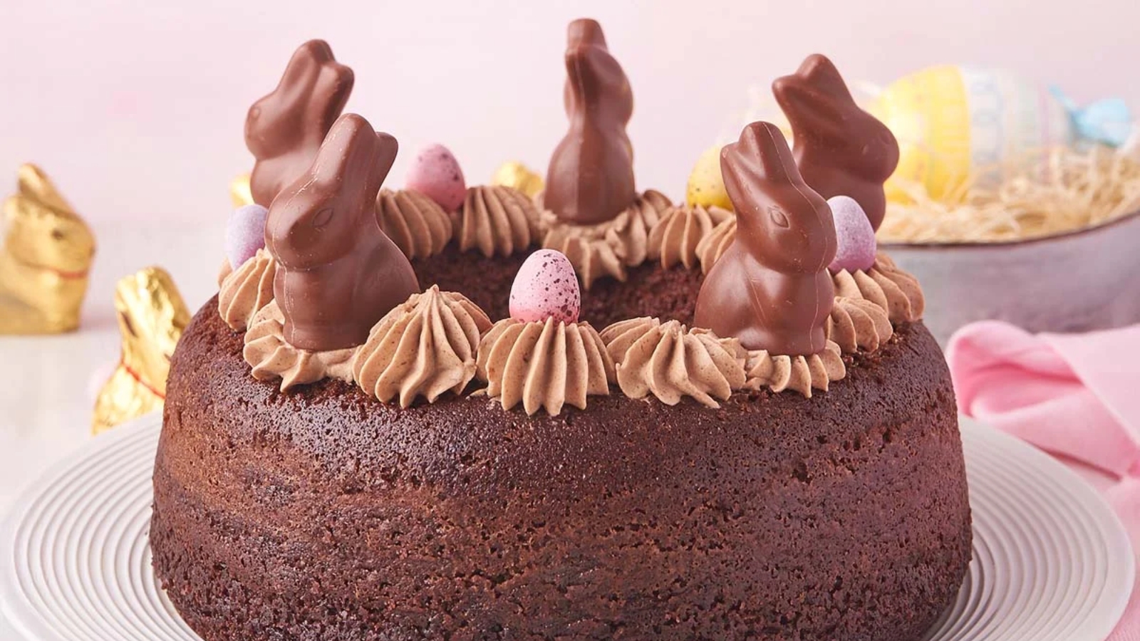 Chocolate Easter bundt cake topped with bunny decorations.