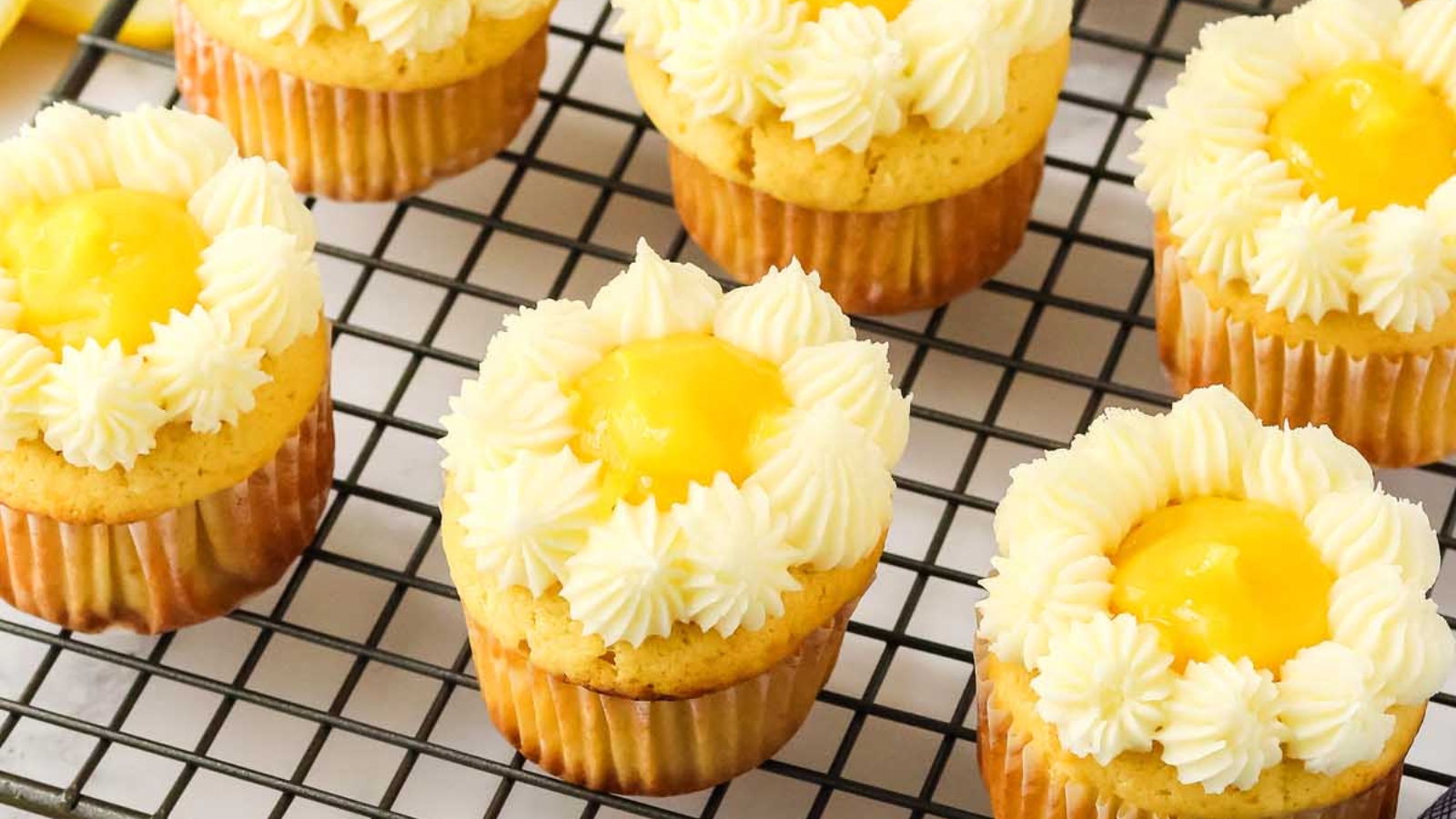 Lemon stuffed cupcakes topped with frosting.