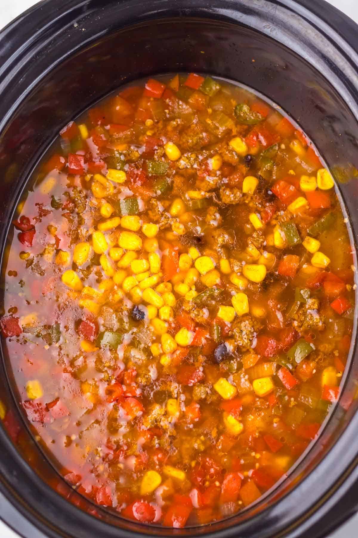Slow Cooker Nacho Soup filled with corn, tomatoes, peppers, and black beans in a savory broth&mdash;an easy recipe for a flavorful meal.