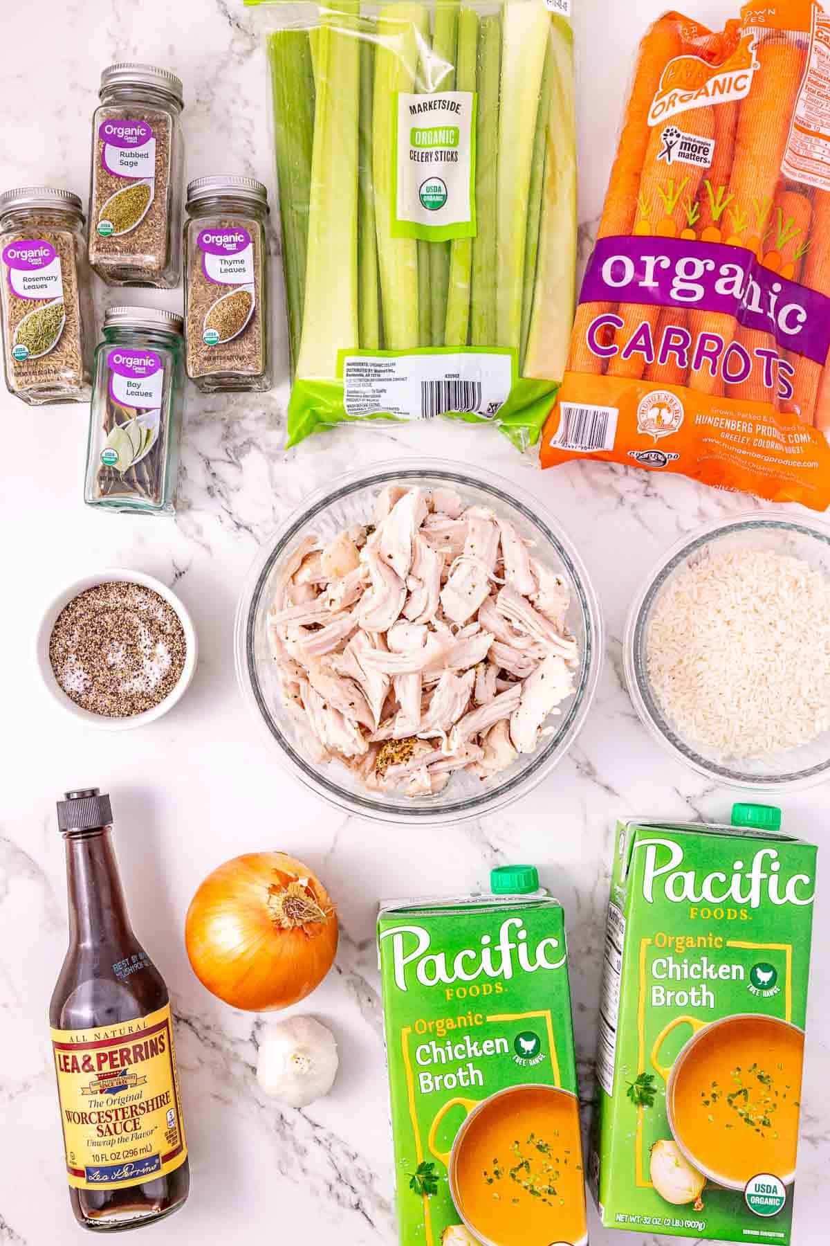 Soup ingredients on a counter: leftover turkey, broth, carrots, celery, onion, rice, spices, and Worcestershire sauce—everything you need for a delicious Slow Cooker Turkey Soup.