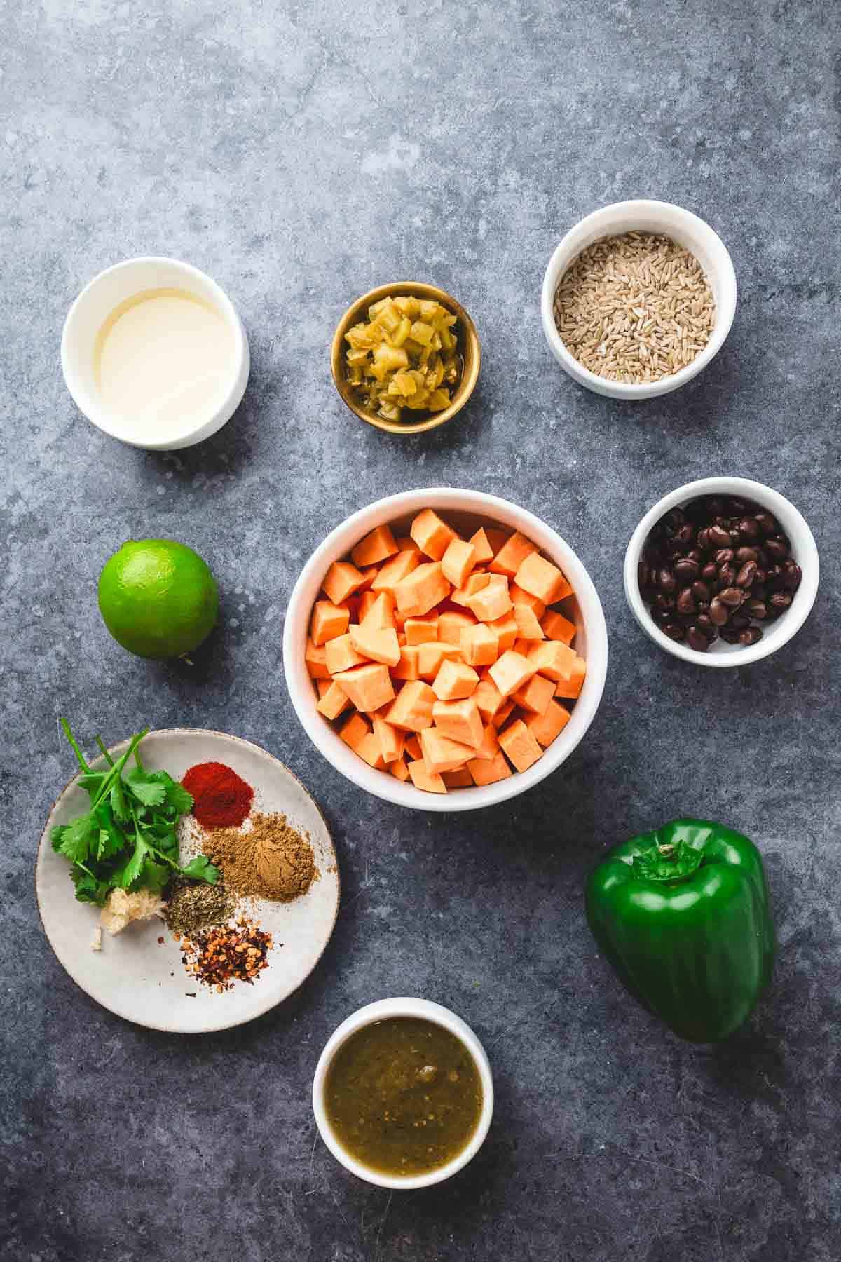 Bowls of diced sweet potato, rice, black beans, spices, green chiles, lime, peppers, salsa, and cilantro make for the perfect Rice Skillet meal.