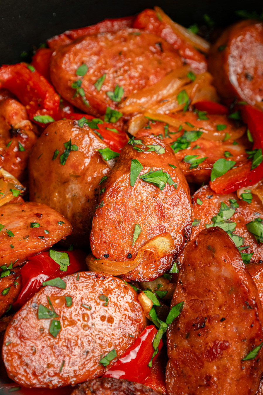 Sliced sausage and potatoes with red peppers, garnished with chopped parsley&mdash;this air fryer kielbasa dish is a flavorful and easy weeknight meal.