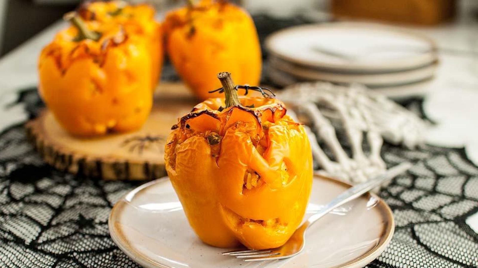 Buffalo chicken stuffed peppers decorated to look like jack-o'-lanterns.