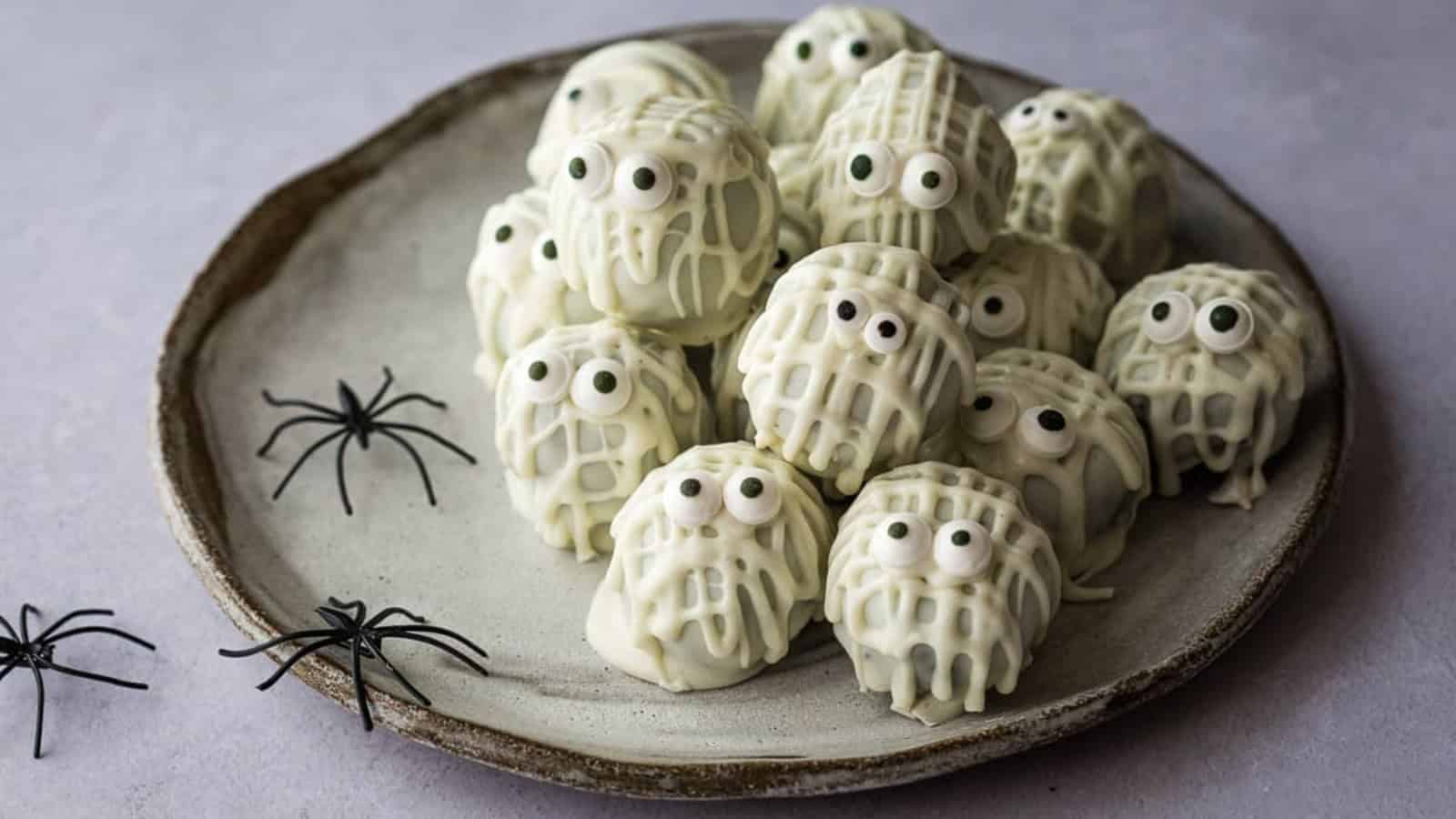 Halloween truffles decorated with festive candy and chocolate.