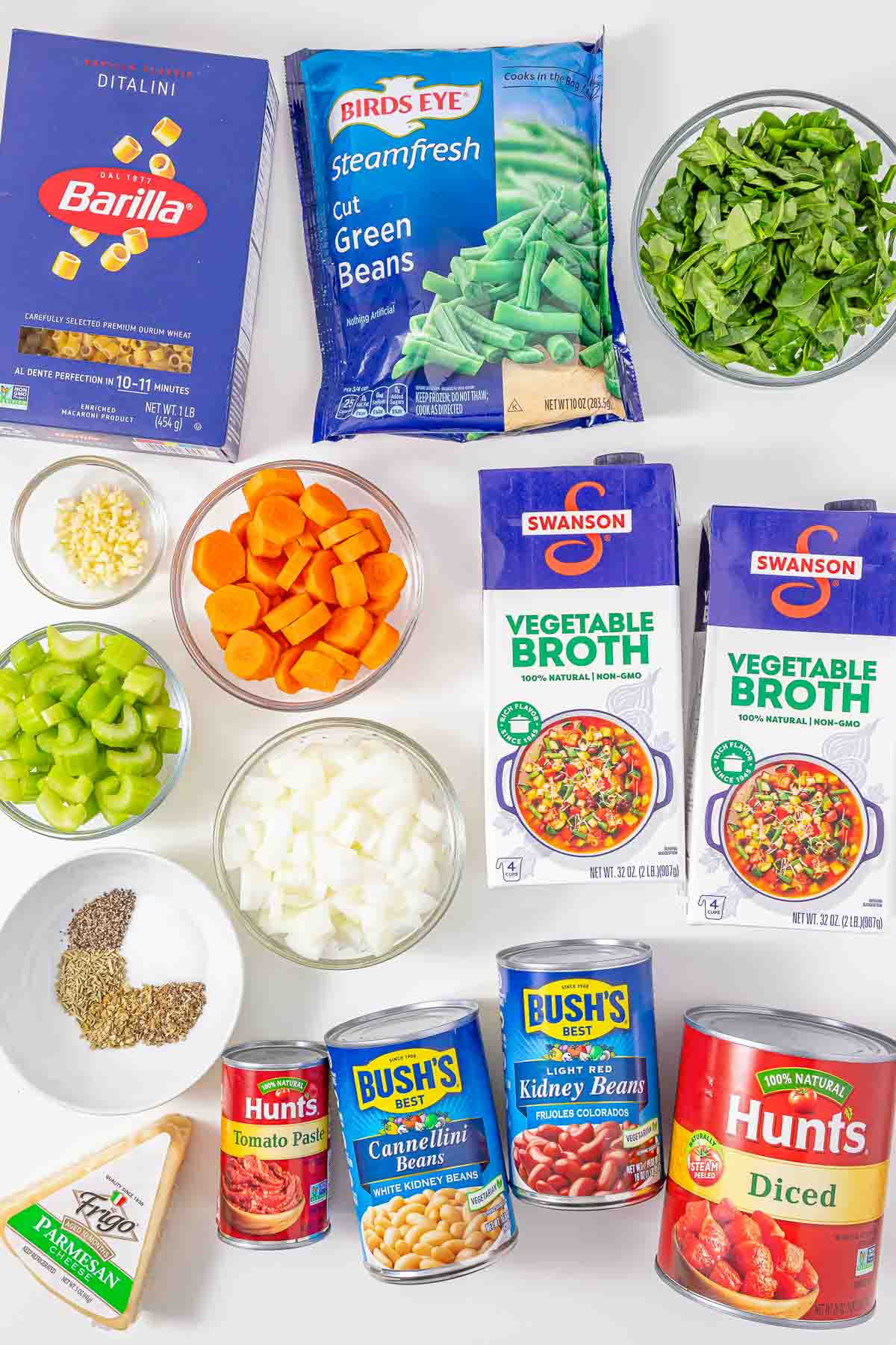 Ingredients for minestrone soup including pasta, green beans, spinach, vegetables, vegetable broth, and canned beans.