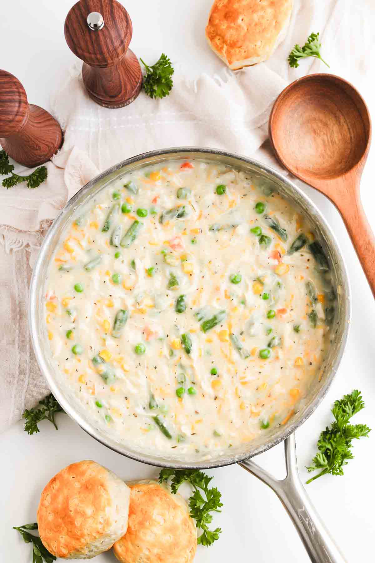 Skillet of Chicken Pot Pie with Biscuits, featuring creamy filling, vegetables, and golden-brown biscuits.