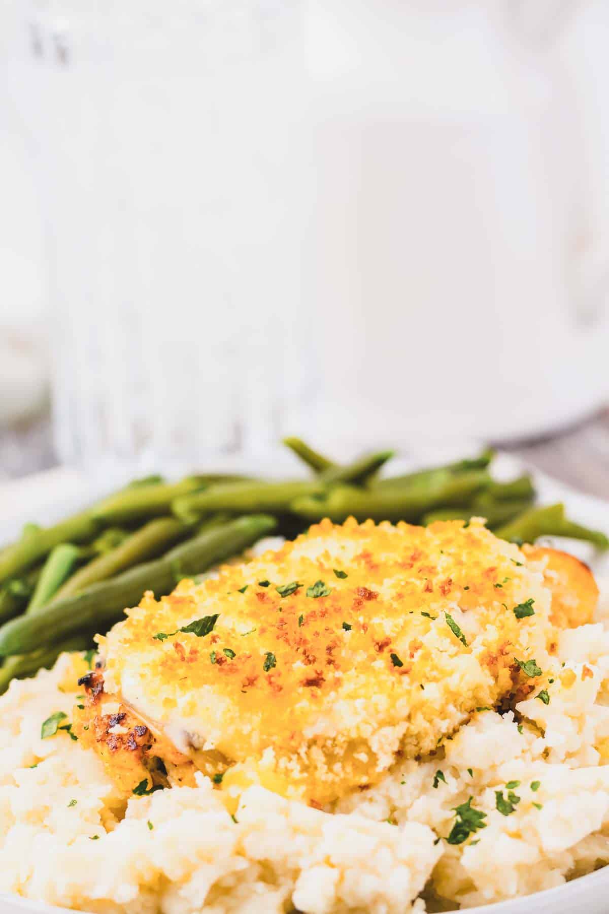 Copycat Longhorn parmesan crusted chicken served with green beans and rice.