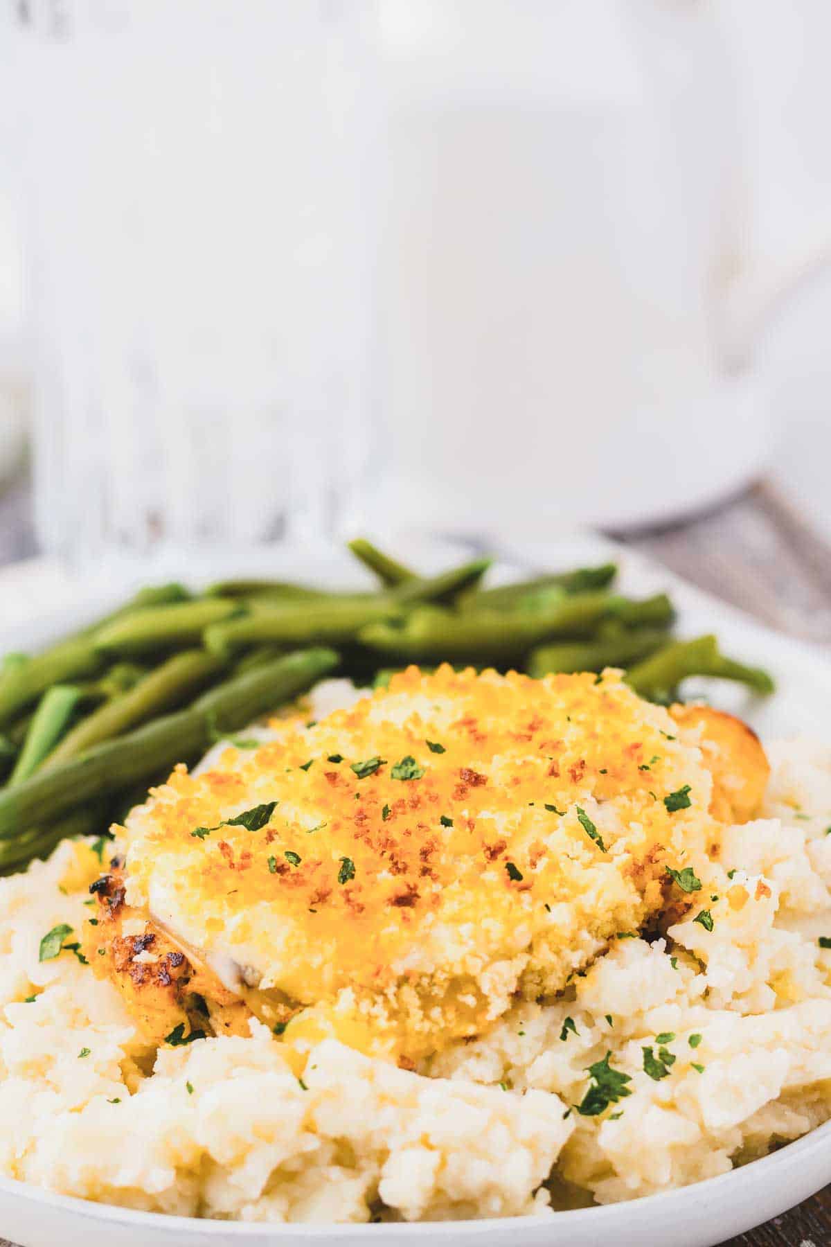 Copycat Longhorn Parmesan crusted chicken served with mashed potatoes and green beans.