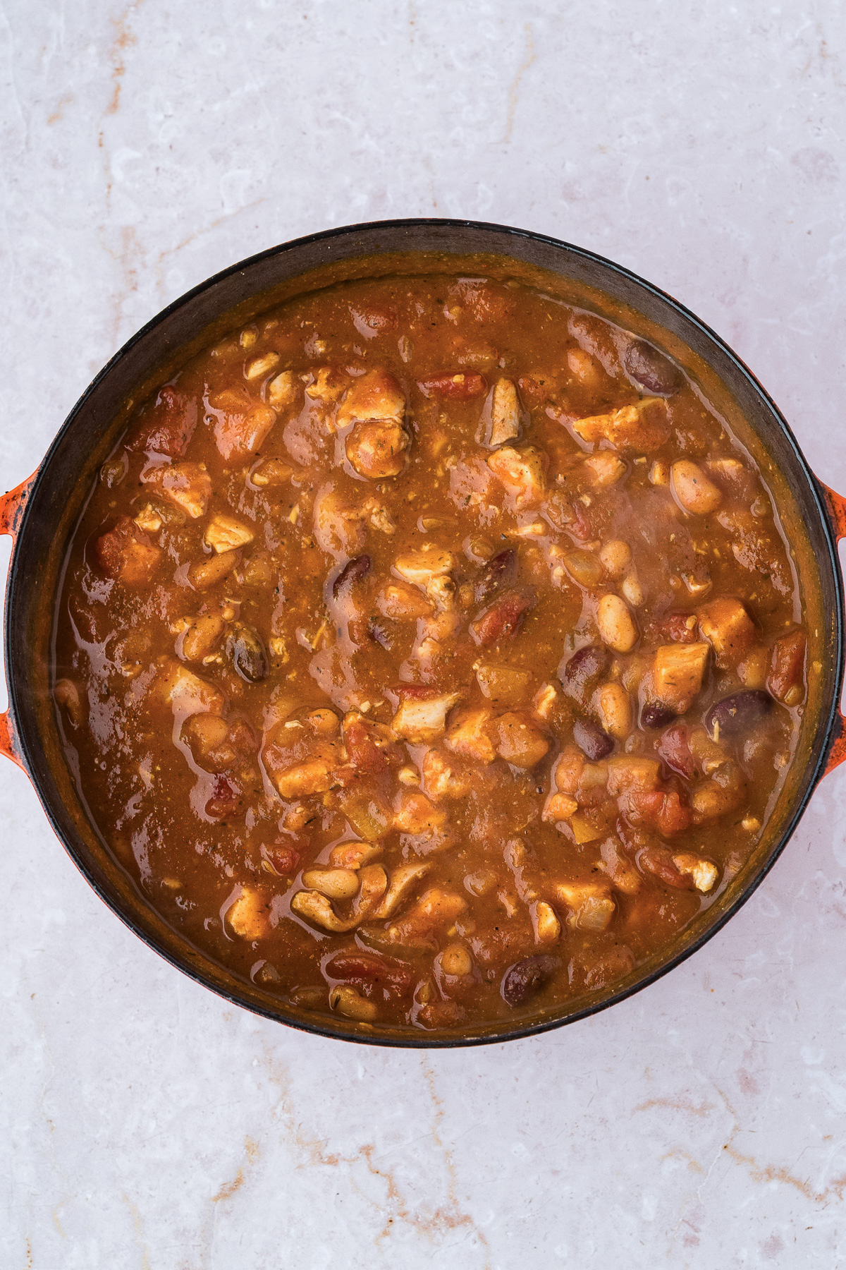 A Dutch oven filled with leftover turkey pumpkin chili.